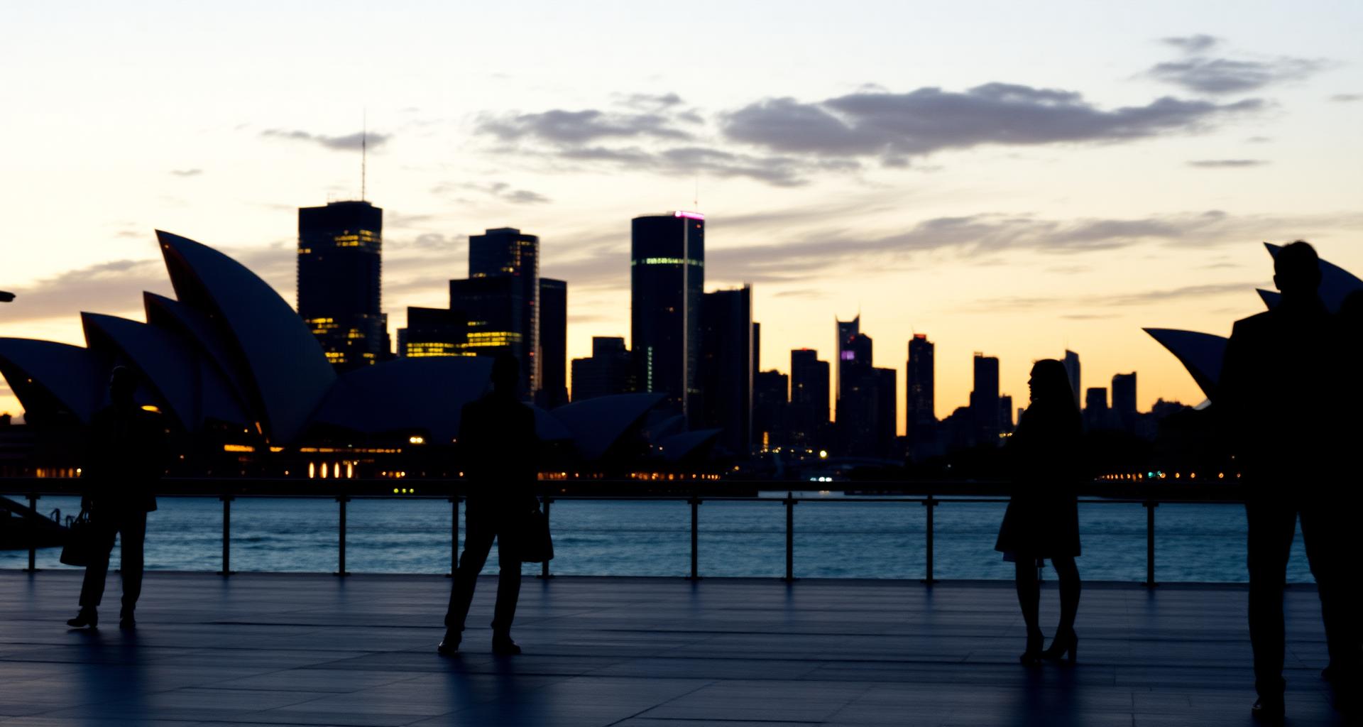 Sydney harbour at dusk with corporate professionals
